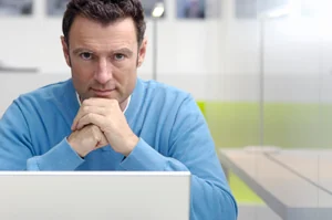 Waiting man behind notebook